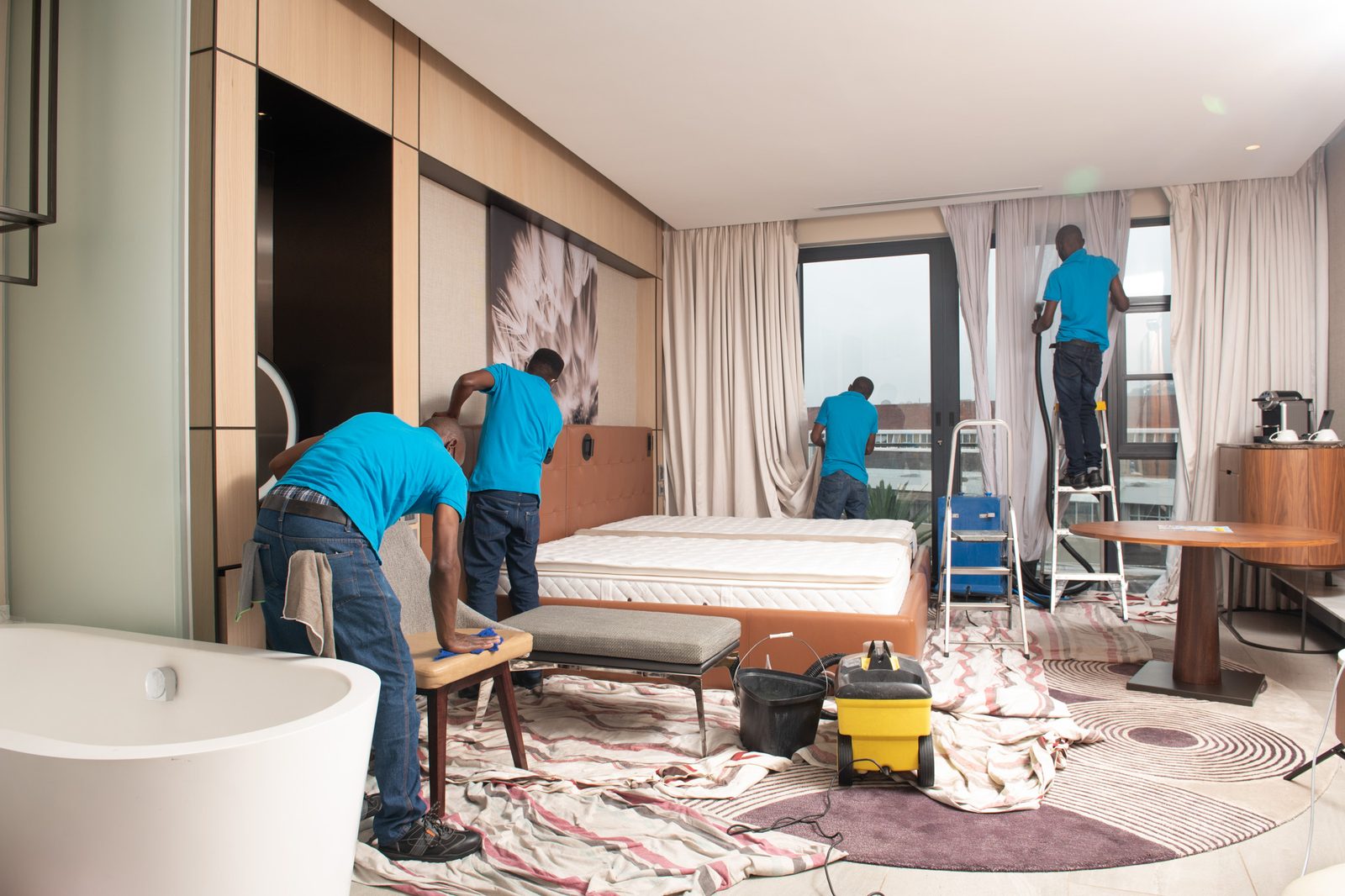 OTS team cleaning hotel curtains and furniture in luxury suite